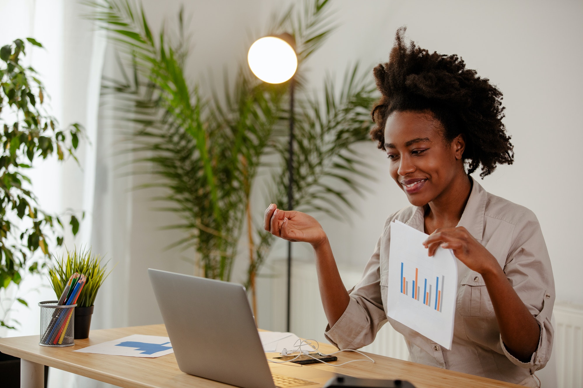 African businesswoman is showing result about market research.