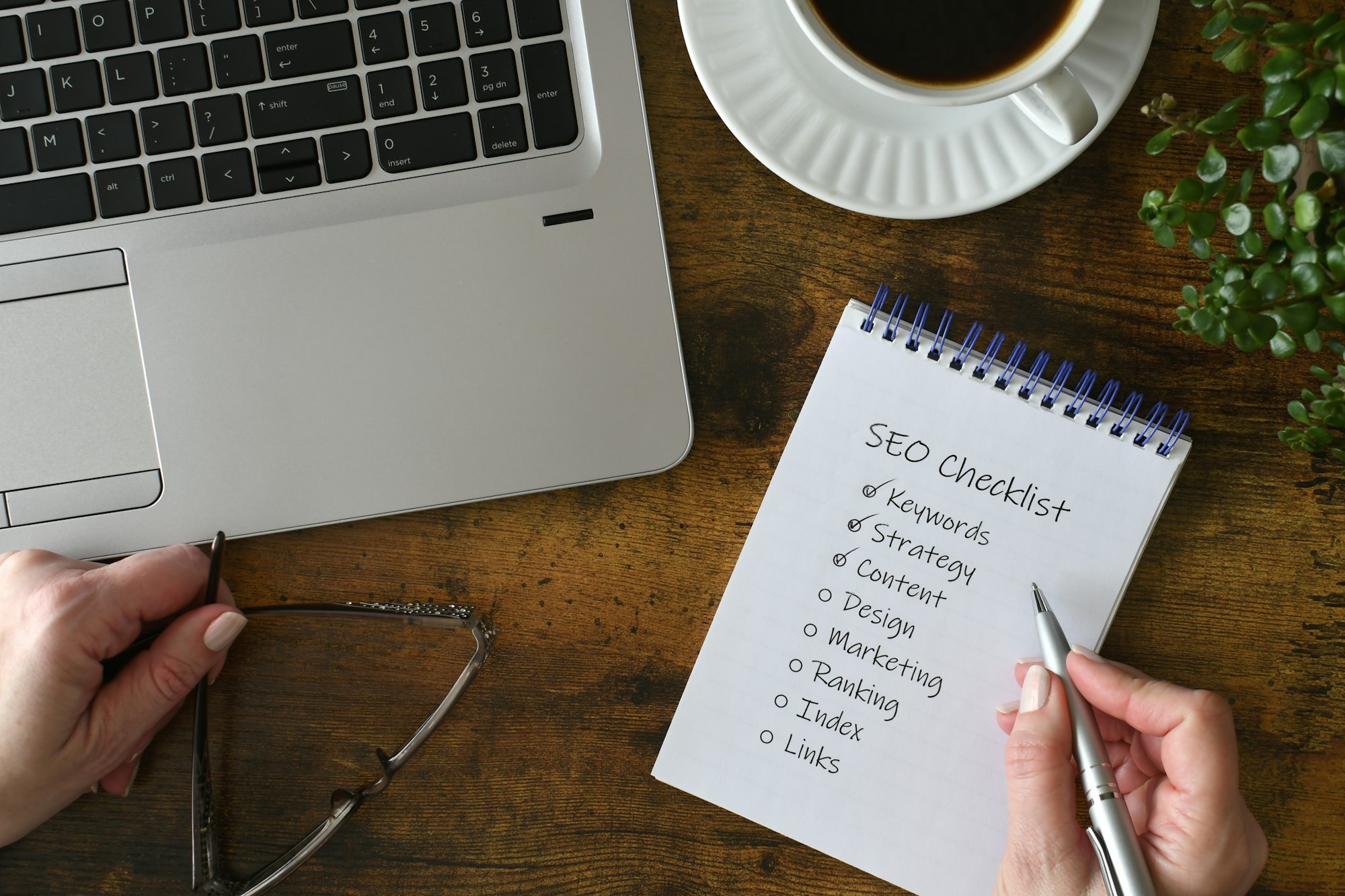 Female checking off items on SEO checklist - search engine optimization